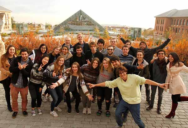 group photo of students in Chili with background of the country