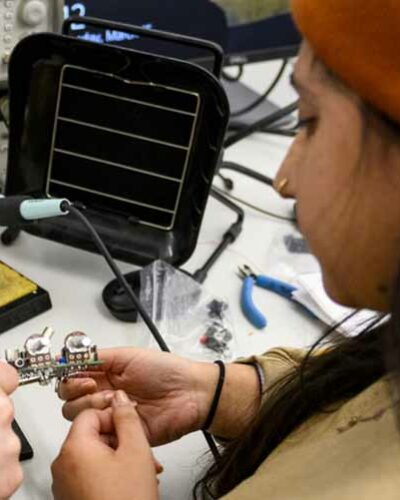 student welding in ECE lab