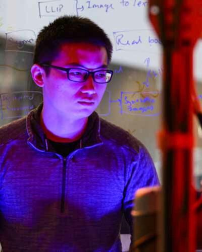 student working on robotic arm