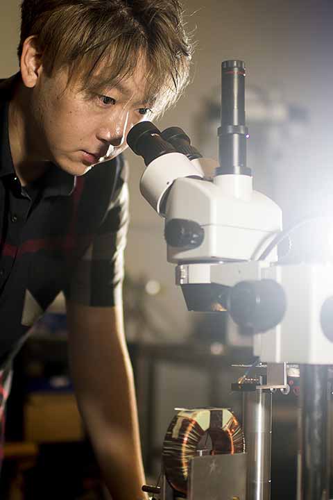 Student looking through microscope